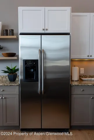 a kitchen with cabinets and stainless steel appliances