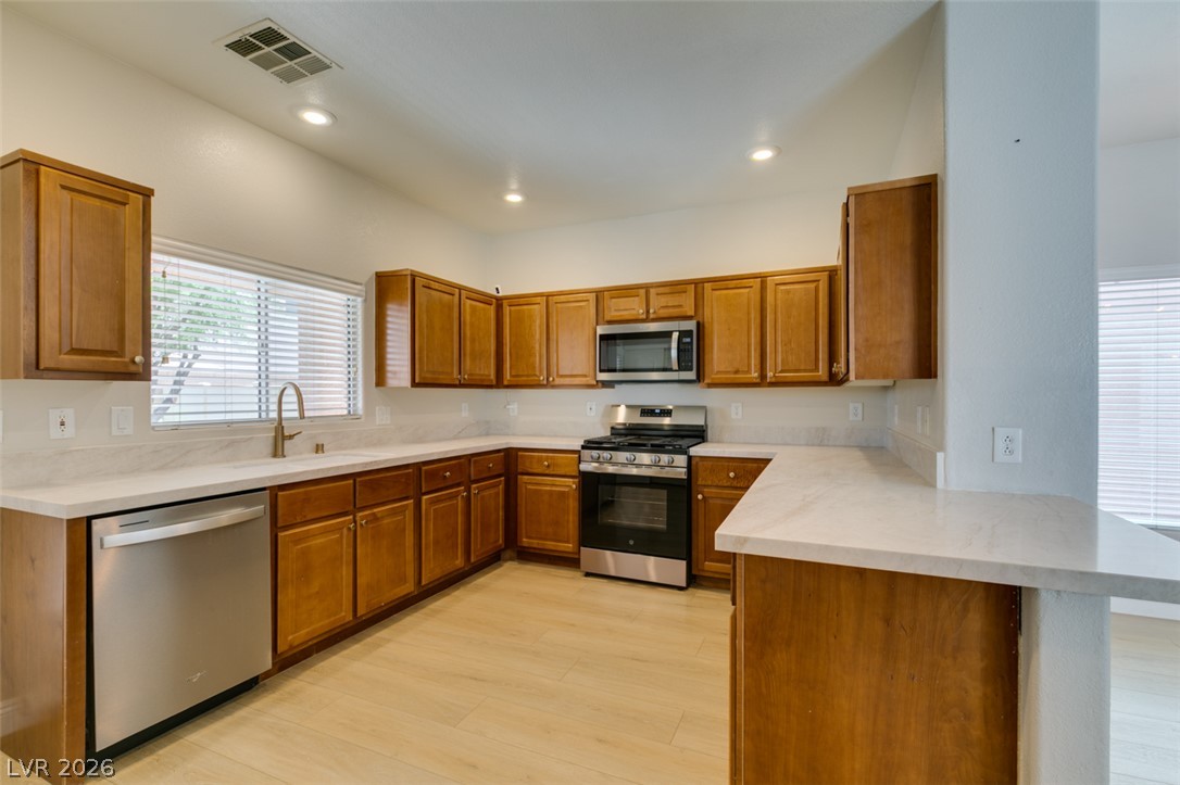 8909 Houston Ridge Avenue Las Vegas, NV 89178 - Photo 16 of 45 A well-appointed culinary space featuring ample wood cabinetry and modern stainless steel appliances.