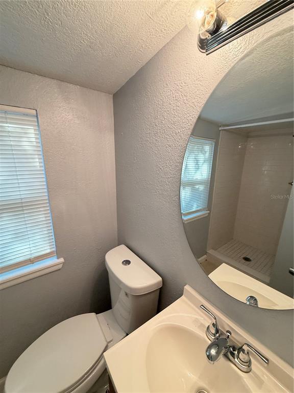4117 Highland Loop New Port Richey, FL 34652 - Photo 11 of 12 a bathroom with a toilet sink and mirror