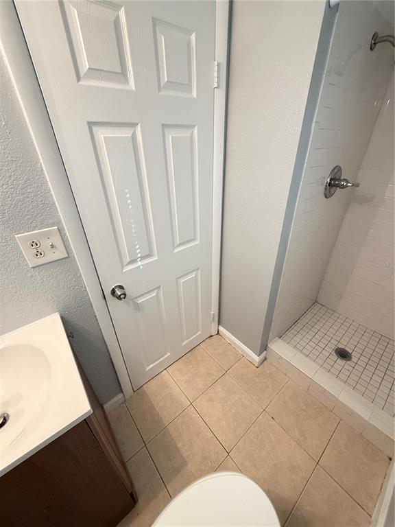 4117 Highland Loop New Port Richey, FL 34652 - Photo 10 of 12 a bathroom with a sink and glass door