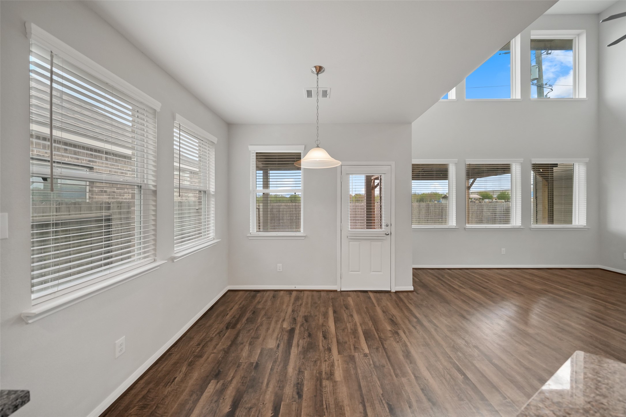 234 Ashley Way Alvin, TX 77511 - Photo 12 of 42 a view of an empty room with wooden floor and a window