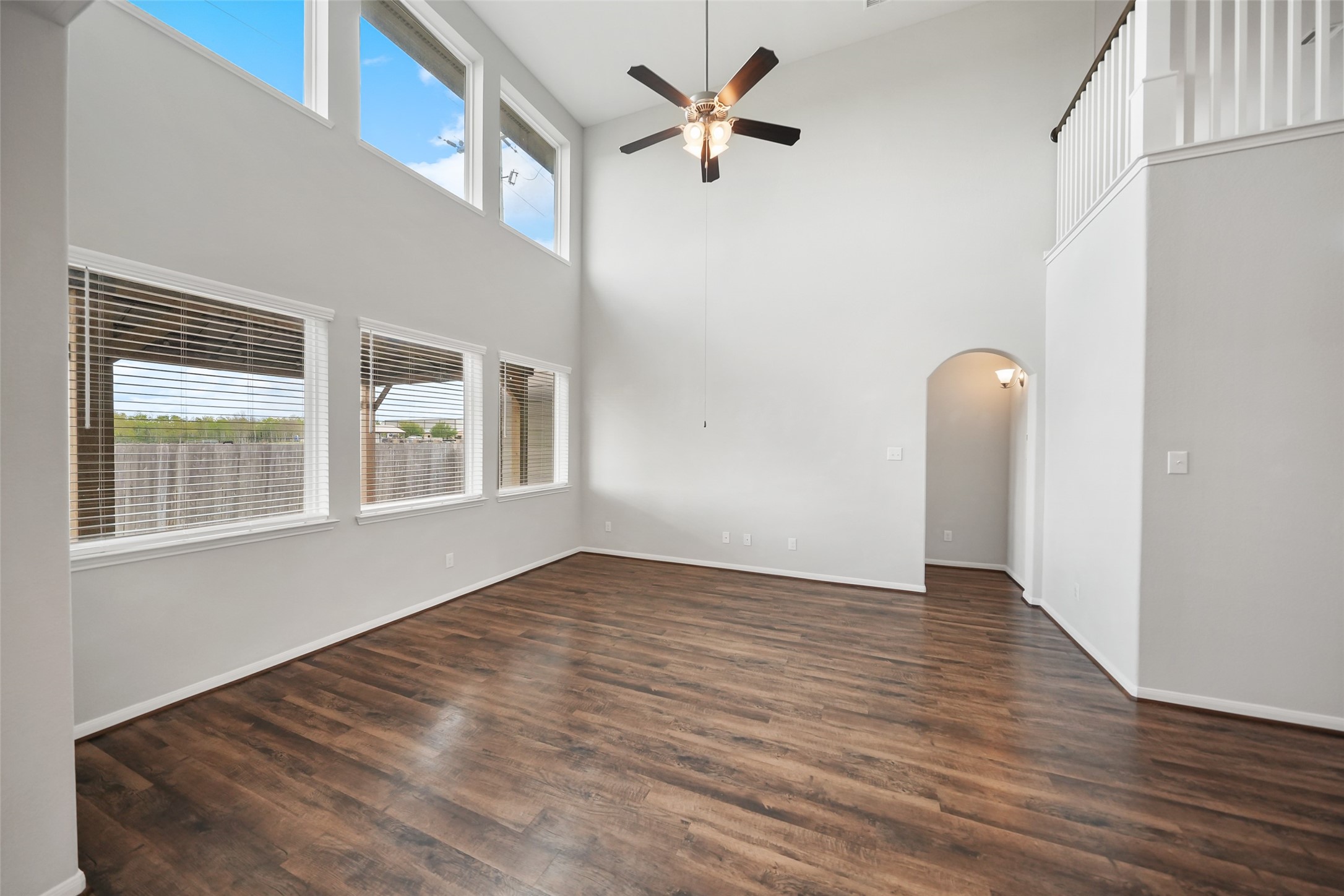 234 Ashley Way Alvin, TX 77511 - Photo 14 of 42 a view of an empty room with a window and wooden floor