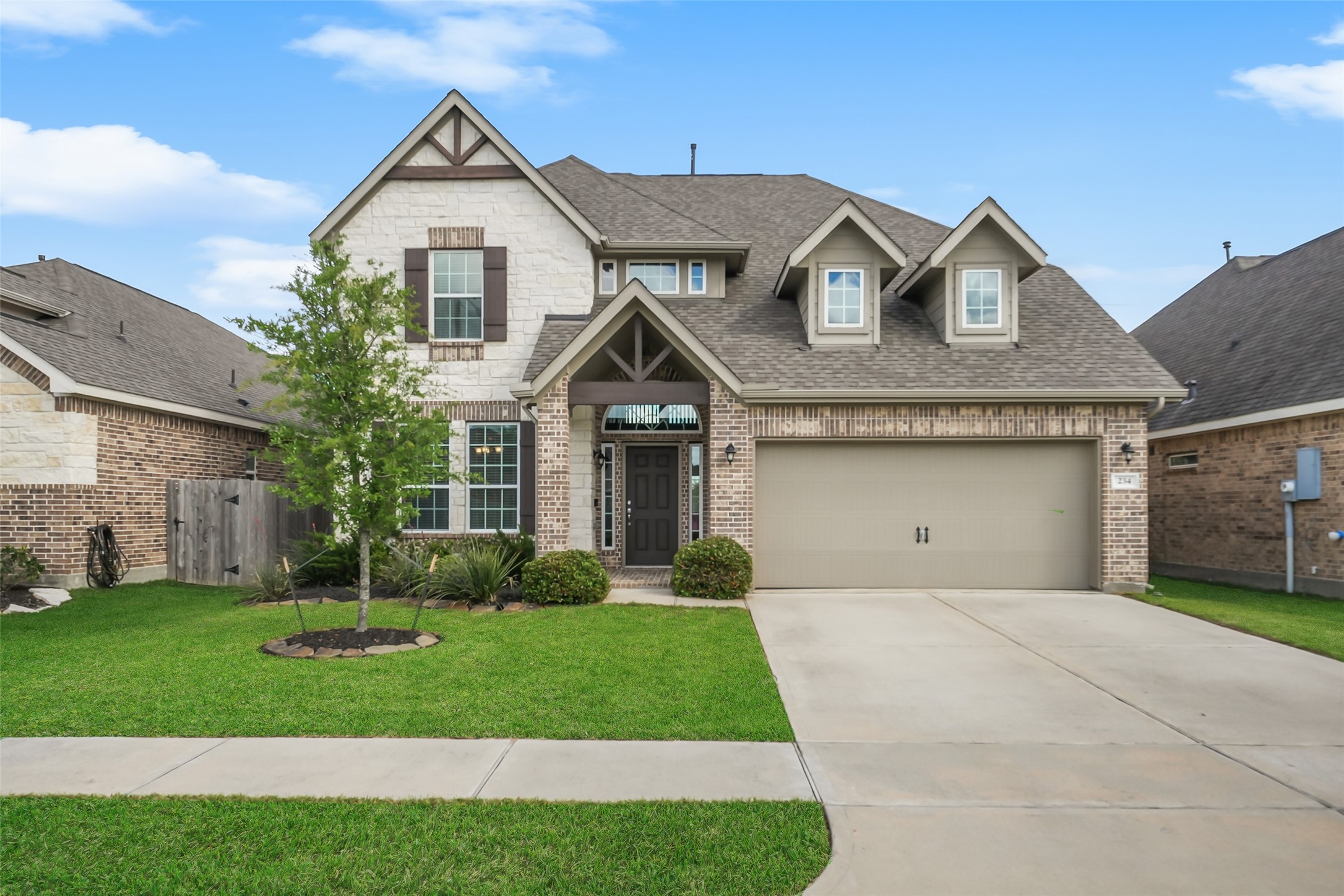 234 Ashley Way Alvin, TX 77511 - Photo 2 of 42 a front view of a house with a yard and garage