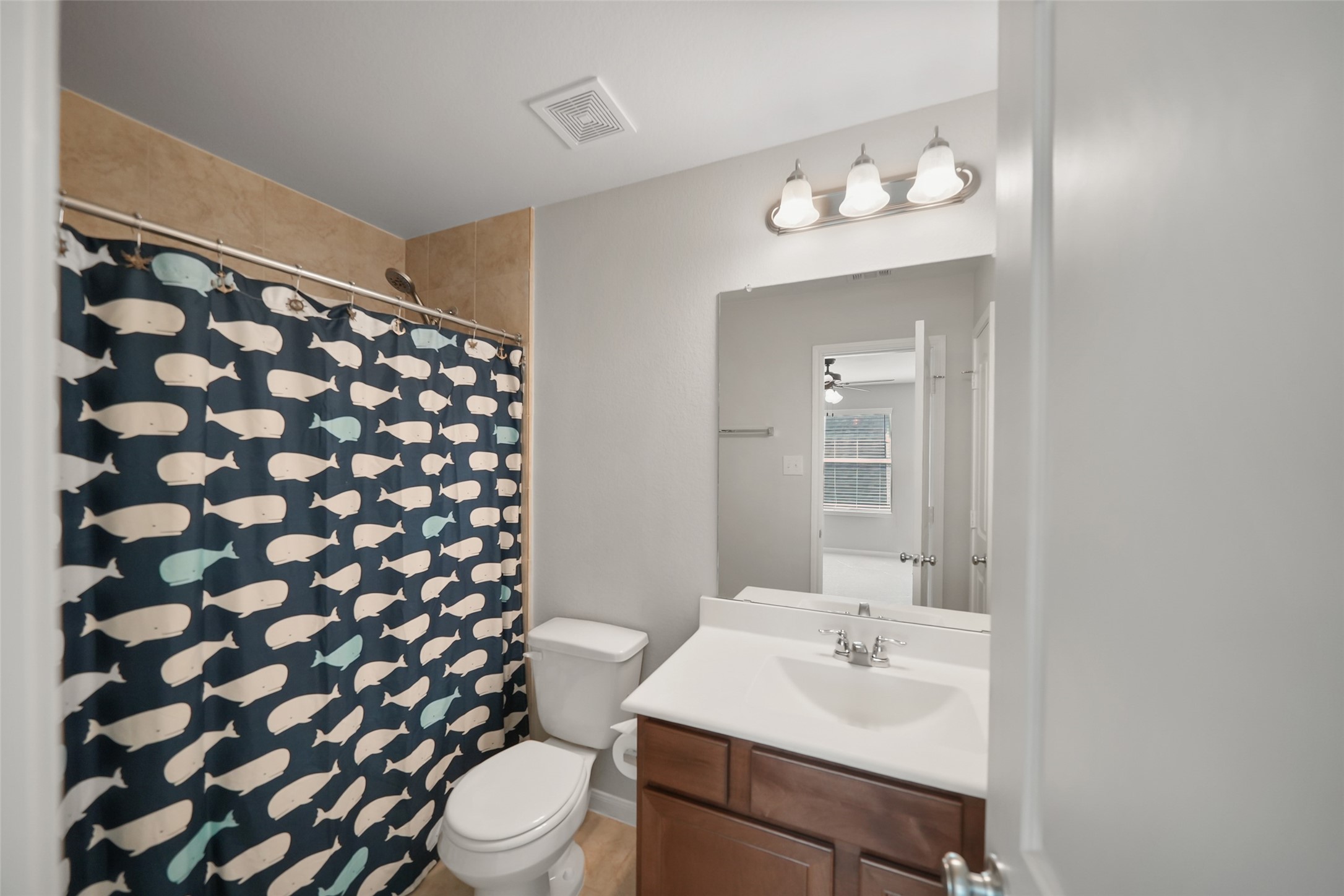 234 Ashley Way Alvin, TX 77511 - Photo 31 of 42 a bathroom with a sink a toilet a mirror and shower curtain