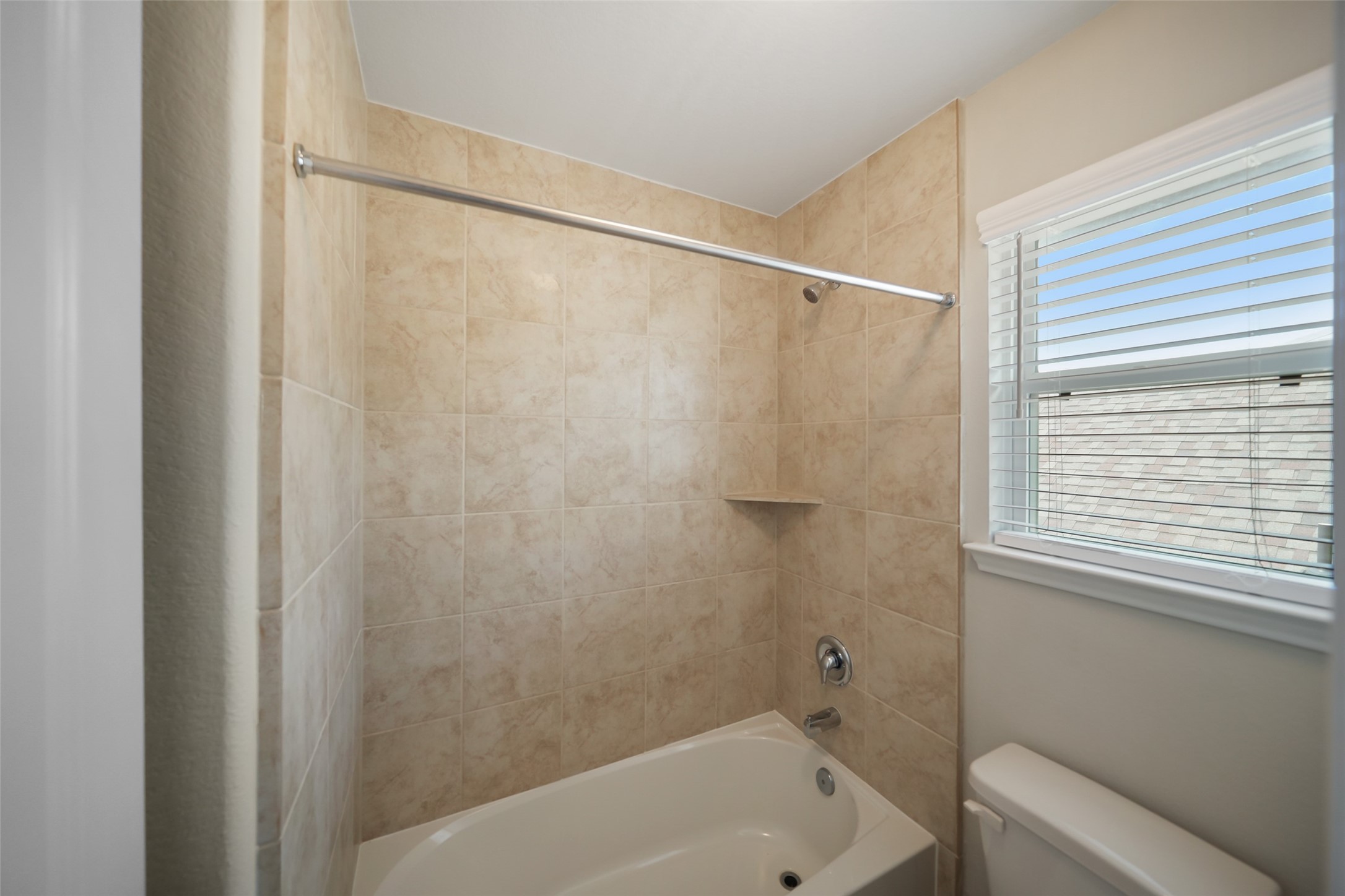 234 Ashley Way Alvin, TX 77511 - Photo 35 of 42 a bathroom with a bathtub and a shower