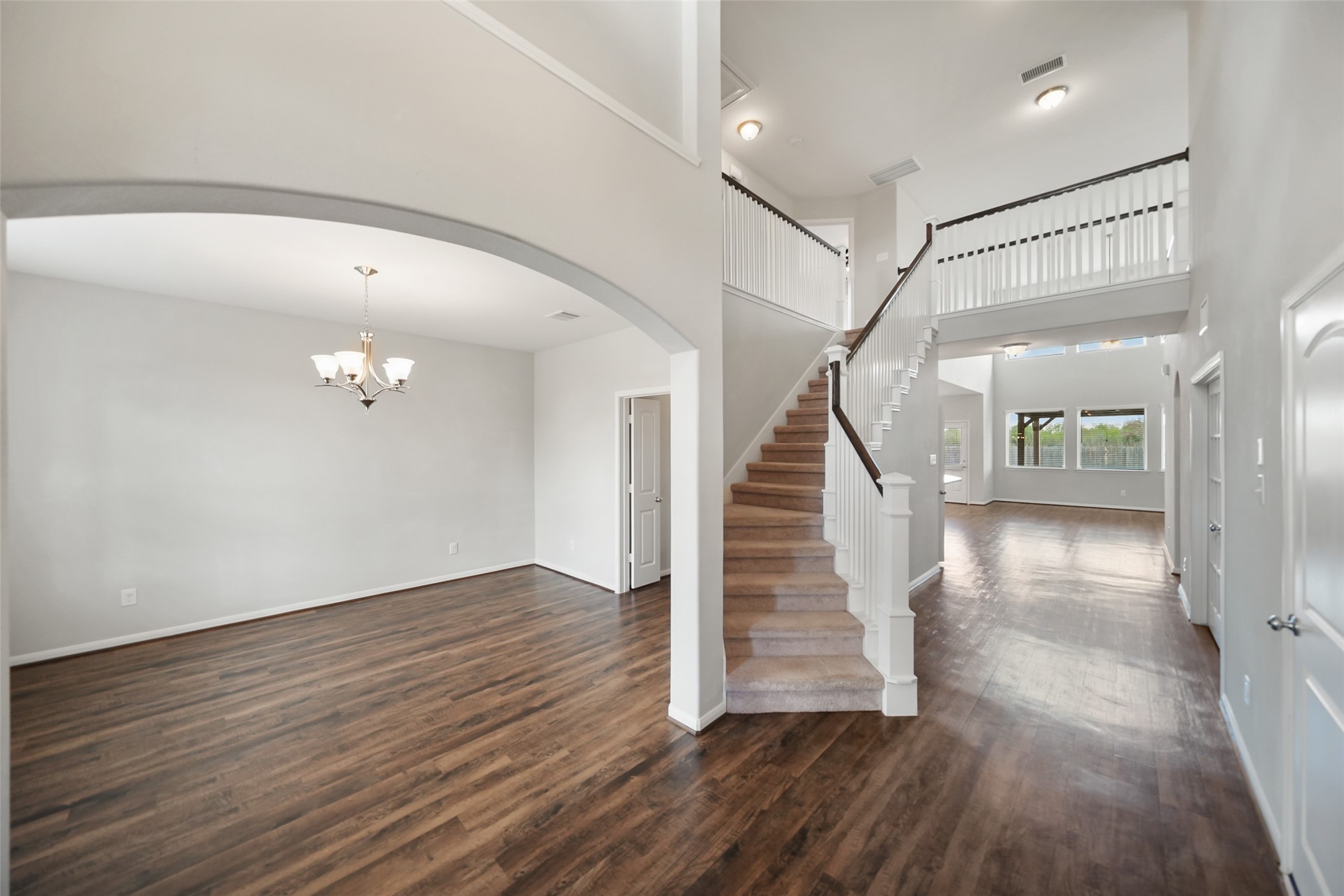 234 Ashley Way Alvin, TX 77511 - Photo 4 of 42 a view of a hallway with wooden floor and stairs