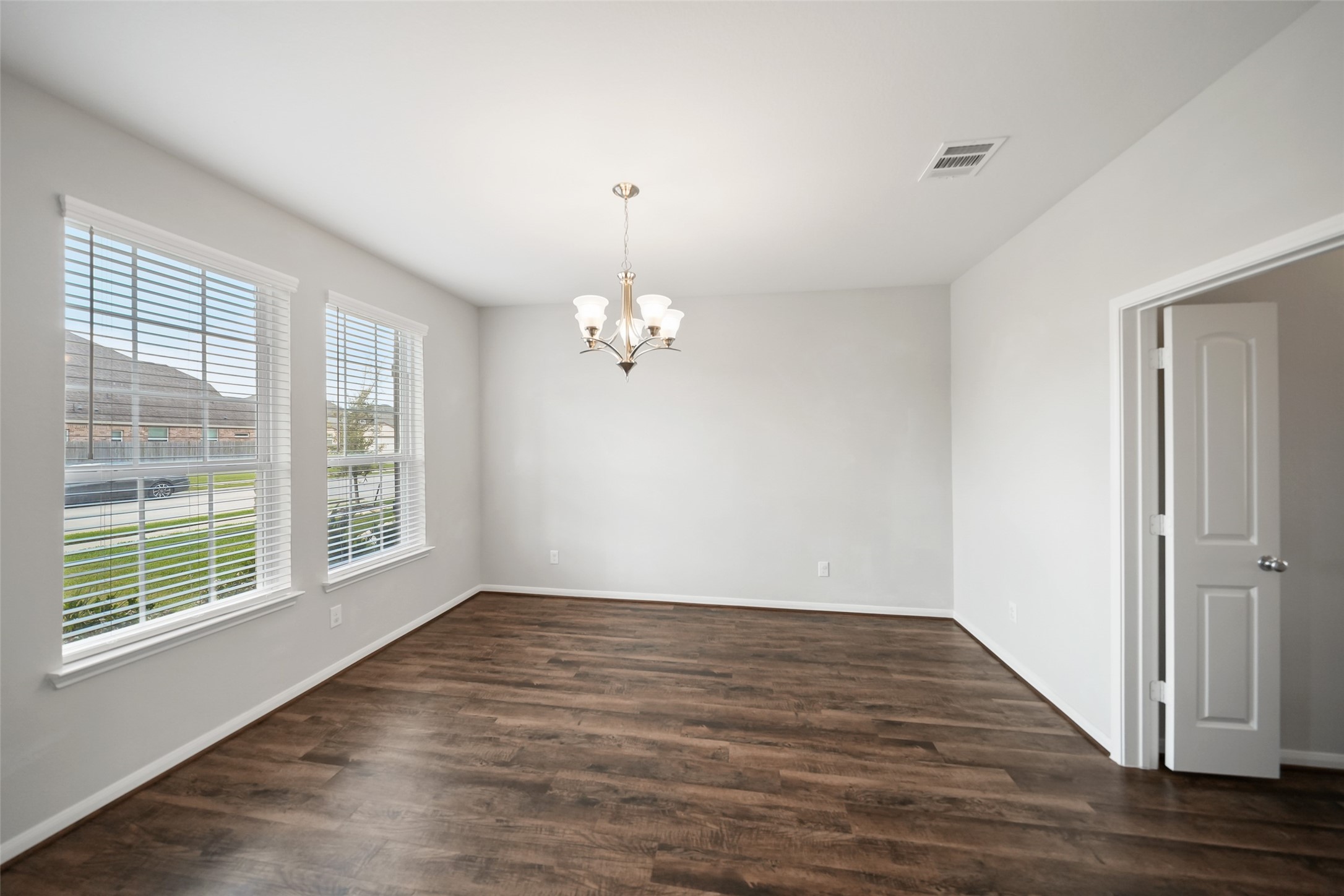 234 Ashley Way Alvin, TX 77511 - Photo 5 of 42 a view of an empty room with wooden floor and a window