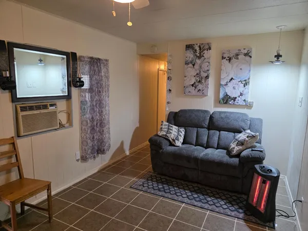 a living room with furniture and a flat screen tv