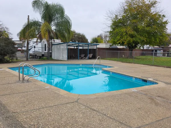a view of a swimming pool with a table and chairs