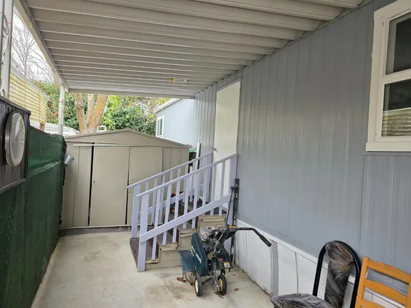 a view of balcony with furniture and a window