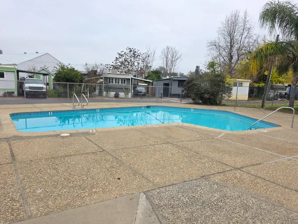a view of a swimming pool with a patio