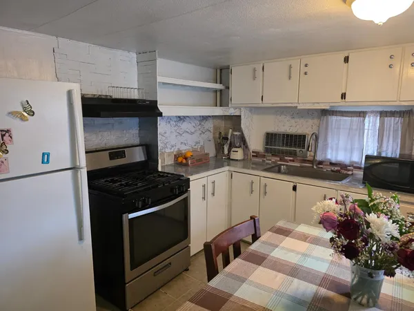a kitchen with cabinets appliances and a counter space