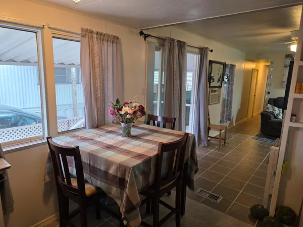 a dining room with furniture and window