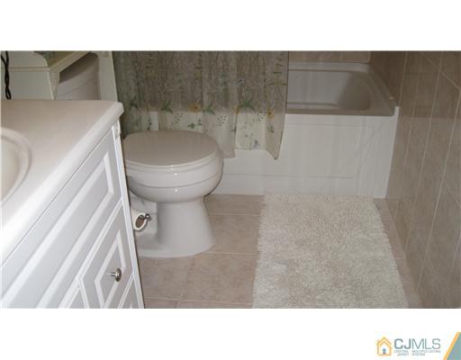 19 Huntington Road Edison, NJ 08820 - Photo 11 of 16 a bathroom with a toilet and a sink