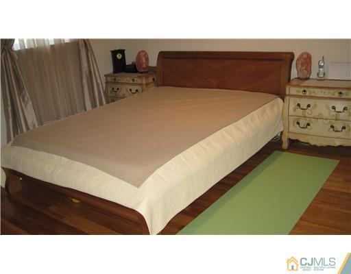 19 Huntington Road Edison, NJ 08820 - Photo 12 of 16 a bedroom with a bed and two night stand