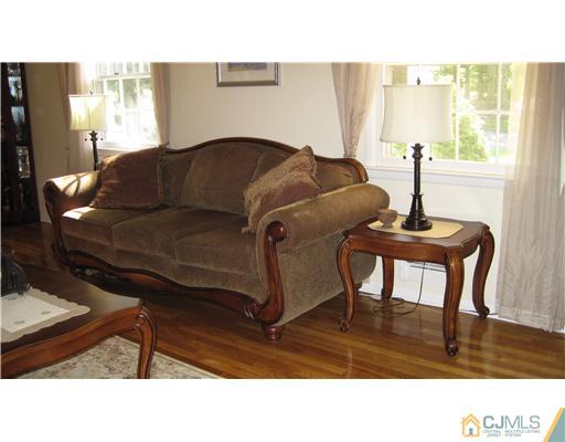 19 Huntington Road Edison, NJ 08820 - Photo 4 of 16 a living room with a couch a window and a potted plant