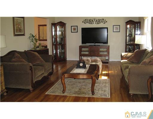 19 Huntington Road Edison, NJ 08820 - Photo 5 of 16 a living room with furniture and a flat screen tv