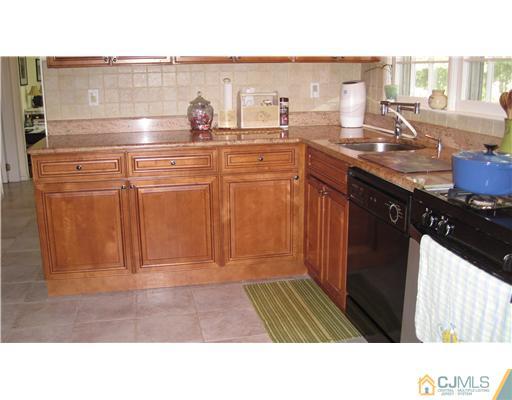 19 Huntington Road Edison, NJ 08820 - Photo 7 of 16 a kitchen with a sink and cabinets