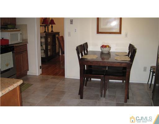 19 Huntington Road Edison, NJ 08820 - Photo 8 of 16 a black and white photo of a dining room