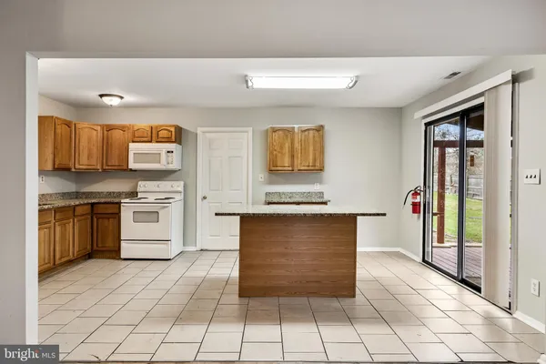 a kitchen with stainless steel appliances granite countertop a stove and a sink
