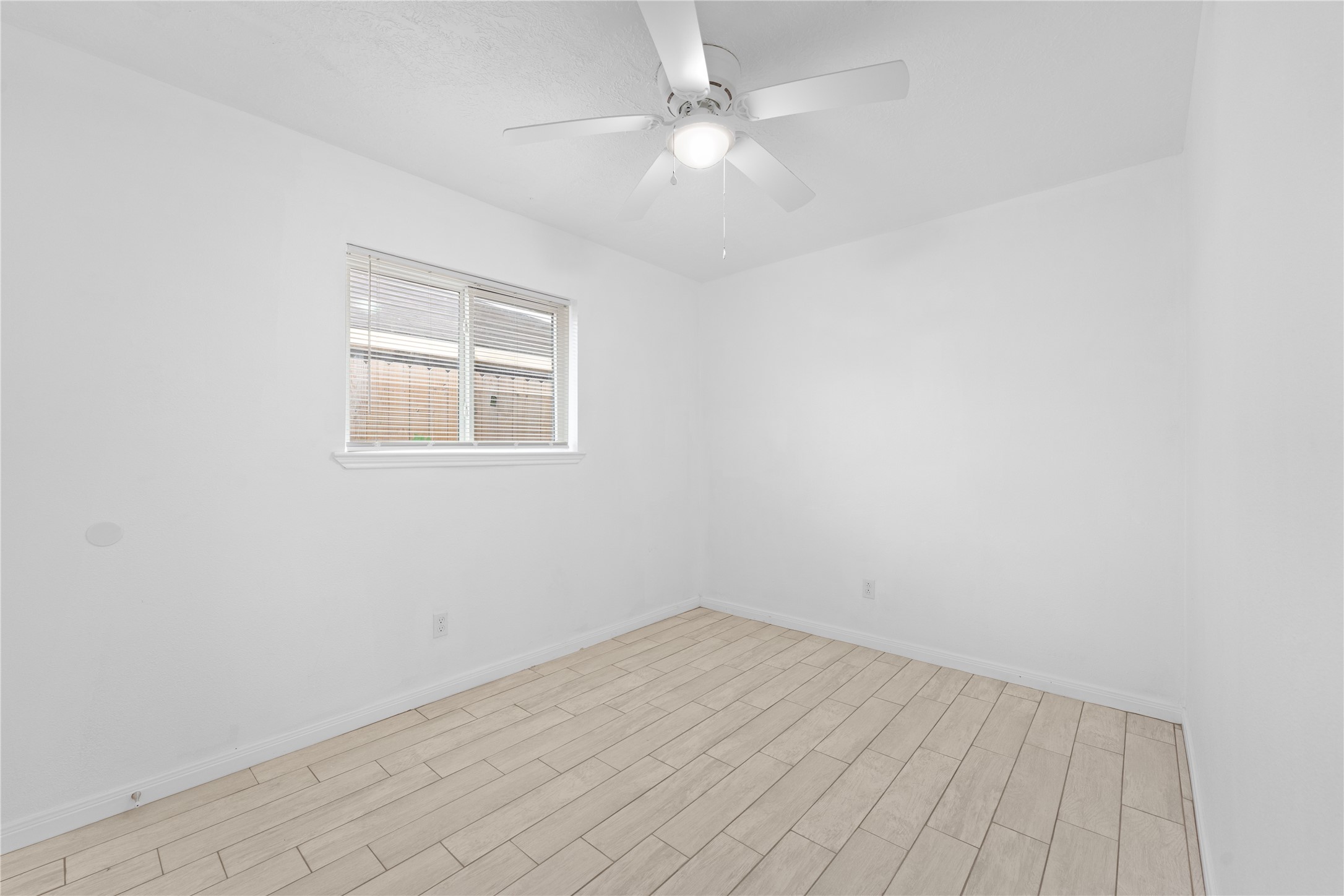 1411 PI Circle Pasadena, TX 77504 - Photo 15 of 26 an empty room with a window and a fan