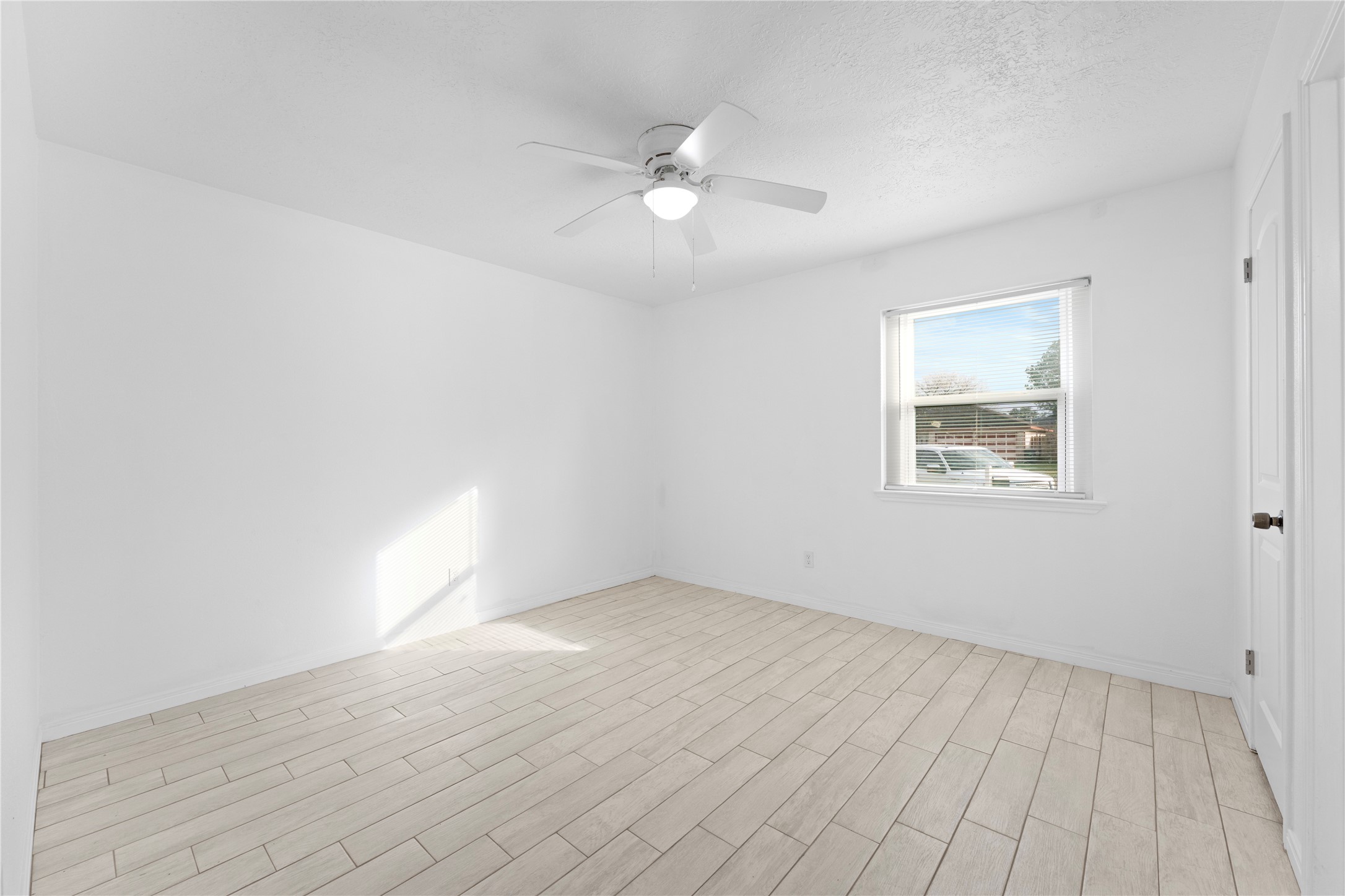 1411 PI Circle Pasadena, TX 77504 - Photo 17 of 26 an empty room with wooden floor and windows