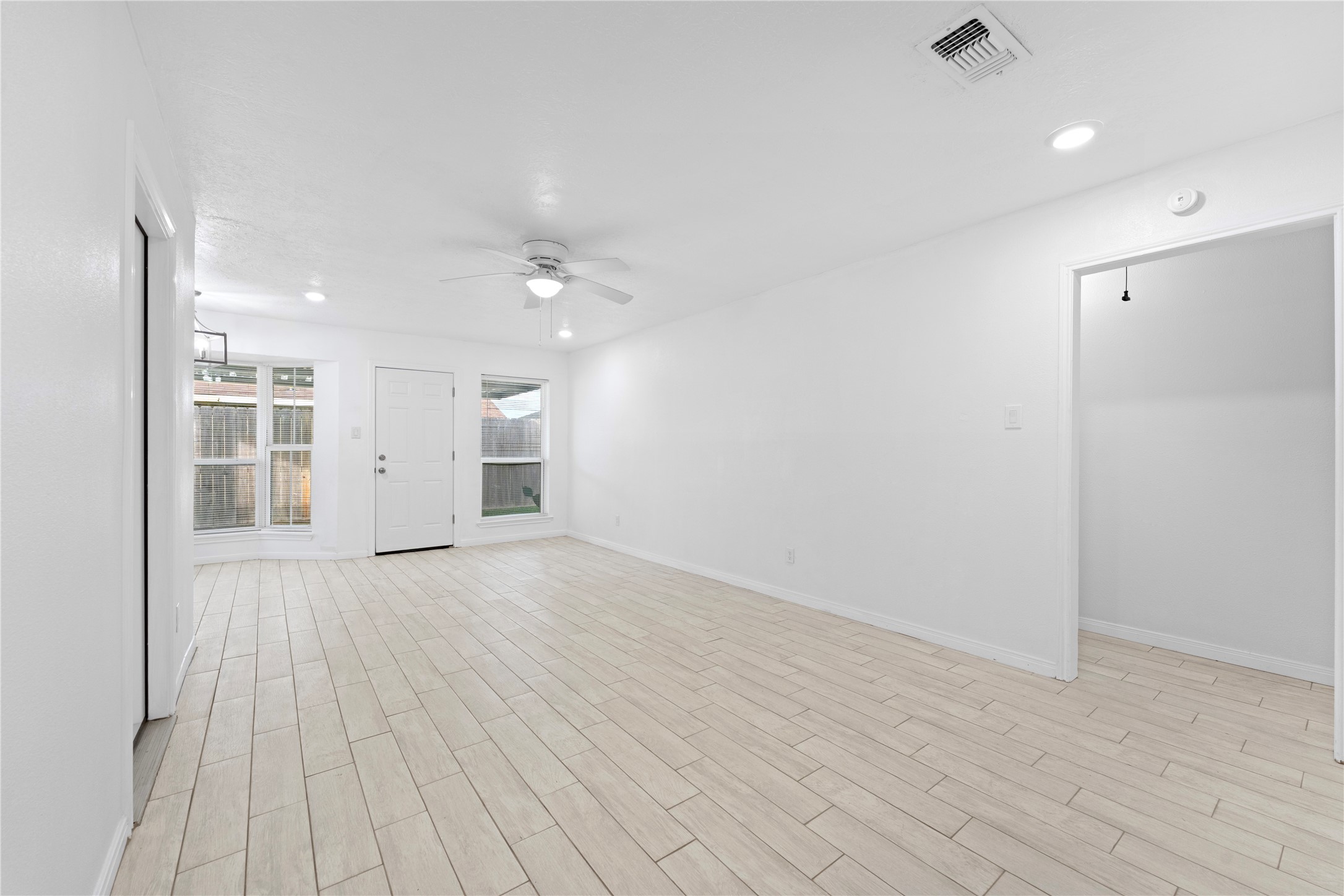 1411 PI Circle Pasadena, TX 77504 - Photo 22 of 26 an empty room with wooden floor and windows