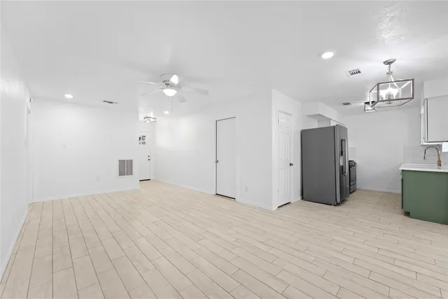 a kitchen with kitchen island a counter top space appliances and cabinets