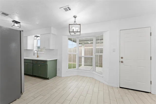 an empty room with a ceiling fan and window