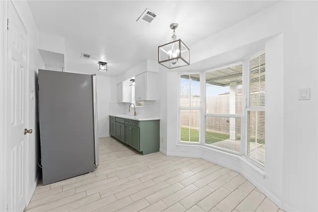 a view of a room with wooden floor and a ceiling fan