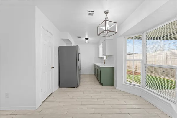 a kitchen with kitchen island a counter top space appliances and cabinets