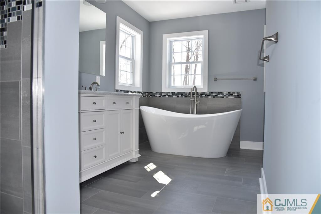171 East Cliff Road Colonia, NJ 07067 - Photo 11 of 25 a spacious bathroom with a bathtub and window