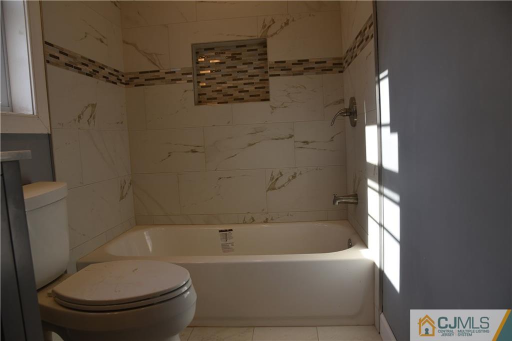 171 East Cliff Road Colonia, NJ 07067 - Photo 14 of 25 a bathroom with a toilet and a bathtub