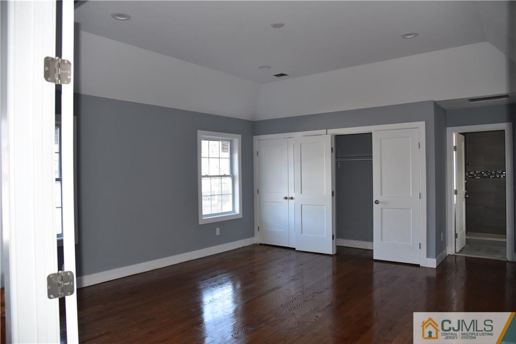 171 East Cliff Road Colonia, NJ 07067 - Photo 15 of 25 a view of an empty room with wooden floor and a window