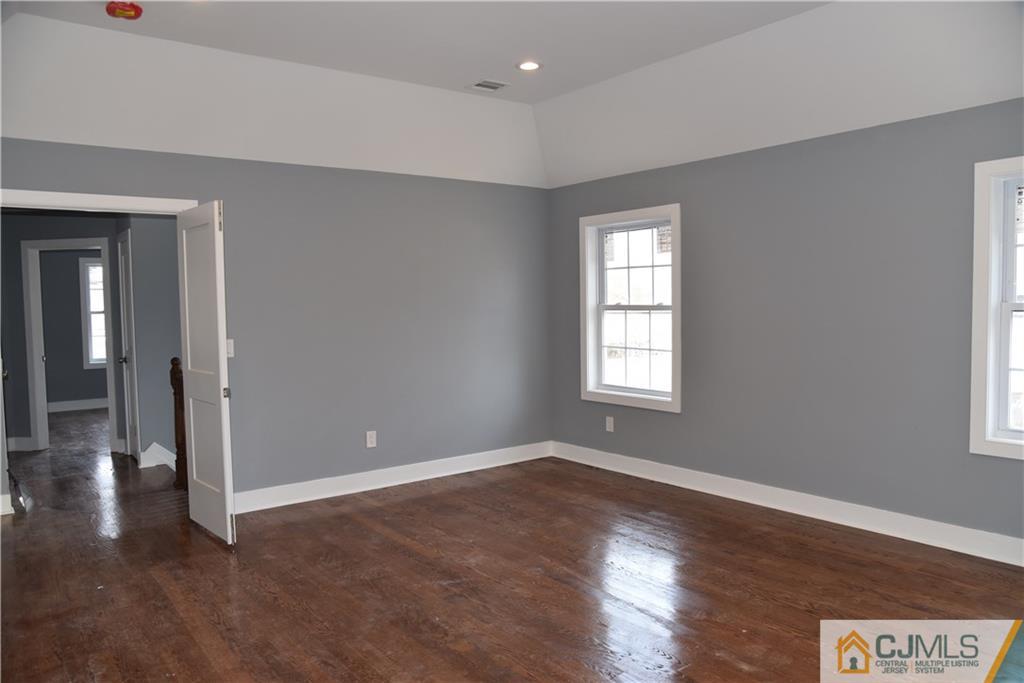 171 East Cliff Road Colonia, NJ 07067 - Photo 16 of 25 a view of an empty room with wooden floor and a window