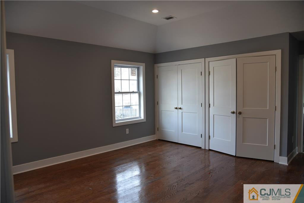 171 East Cliff Road Colonia, NJ 07067 - Photo 17 of 25 an empty room with wooden floor and window