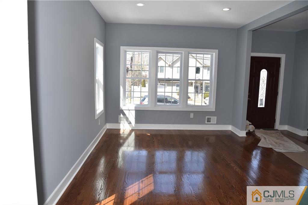 171 East Cliff Road Colonia, NJ 07067 - Photo 18 of 25 a view of an empty room with wooden floor and a window