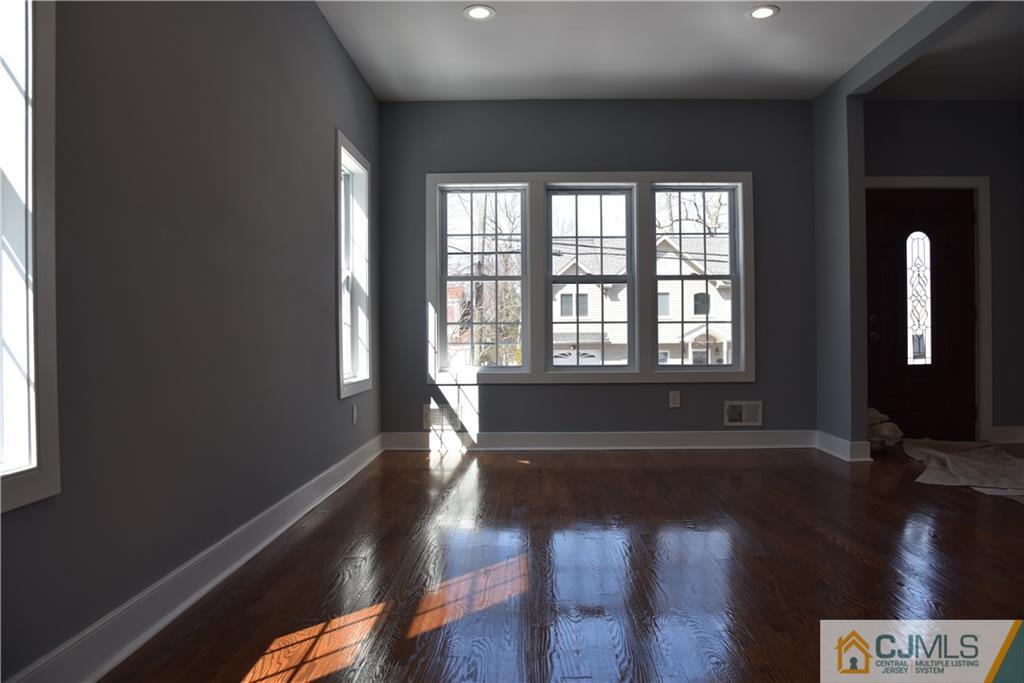 171 East Cliff Road Colonia, NJ 07067 - Photo 19 of 25 a view of an empty room with wooden floor and a window