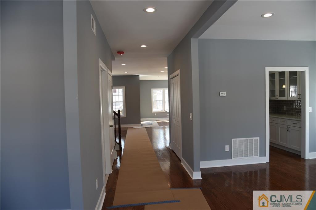 171 East Cliff Road Colonia, NJ 07067 - Photo 3 of 25 a view of a hallway view with wooden floor and living room