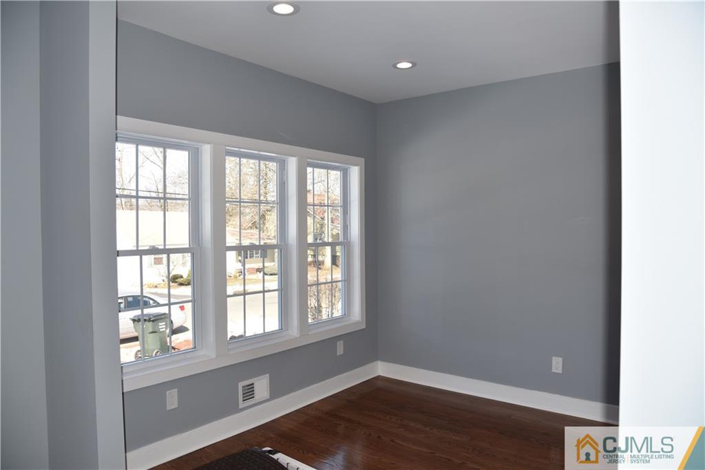 171 East Cliff Road Colonia, NJ 07067 - Photo 21 of 25 a view of empty room with wooden floor and fan