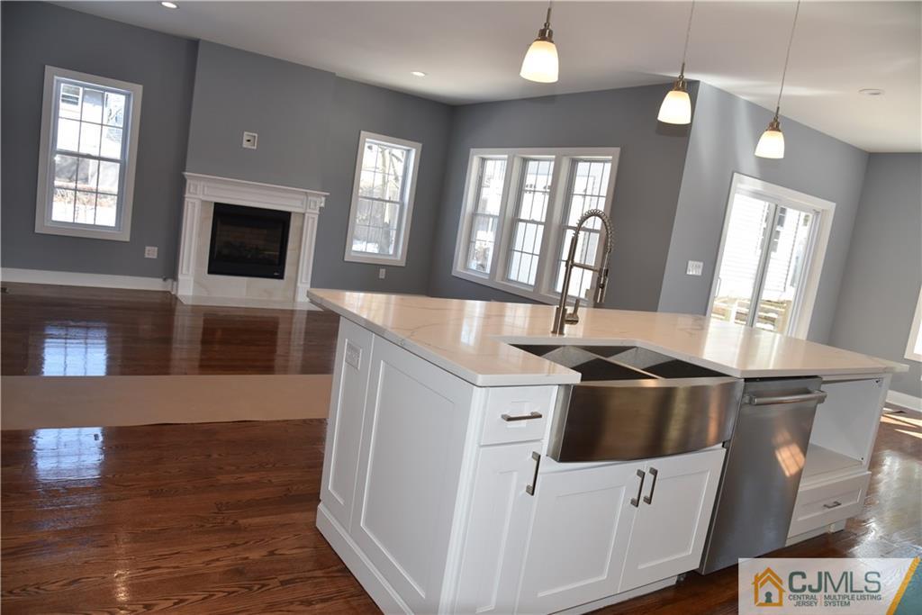 171 East Cliff Road Colonia, NJ 07067 - Photo 5 of 25 a kitchen with stainless steel appliances granite countertop a sink a stove and a wooden floors