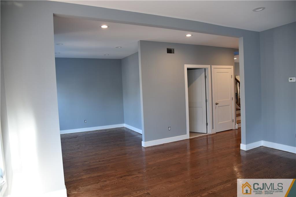 171 East Cliff Road Colonia, NJ 07067 - Photo 7 of 25 a view of an empty room with wooden floor and closet