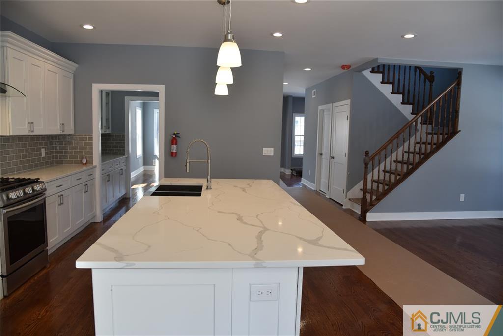 171 East Cliff Road Colonia, NJ 07067 - Photo 10 of 25 a kitchen with a stove a sink and a refrigerator