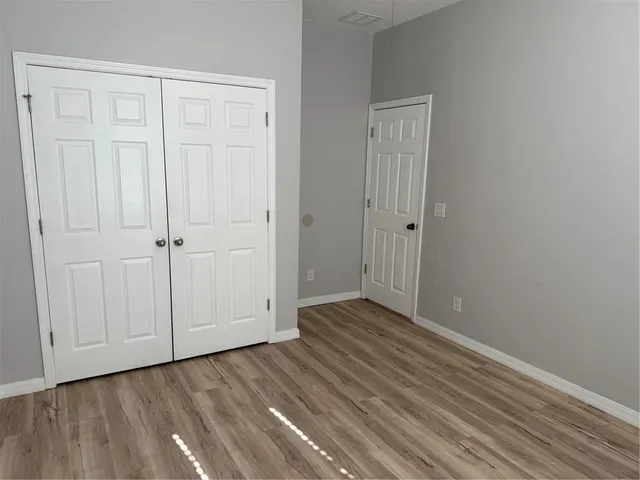 an empty room with wooden floor
