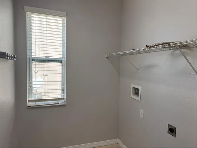 a bathroom with a window and a shower