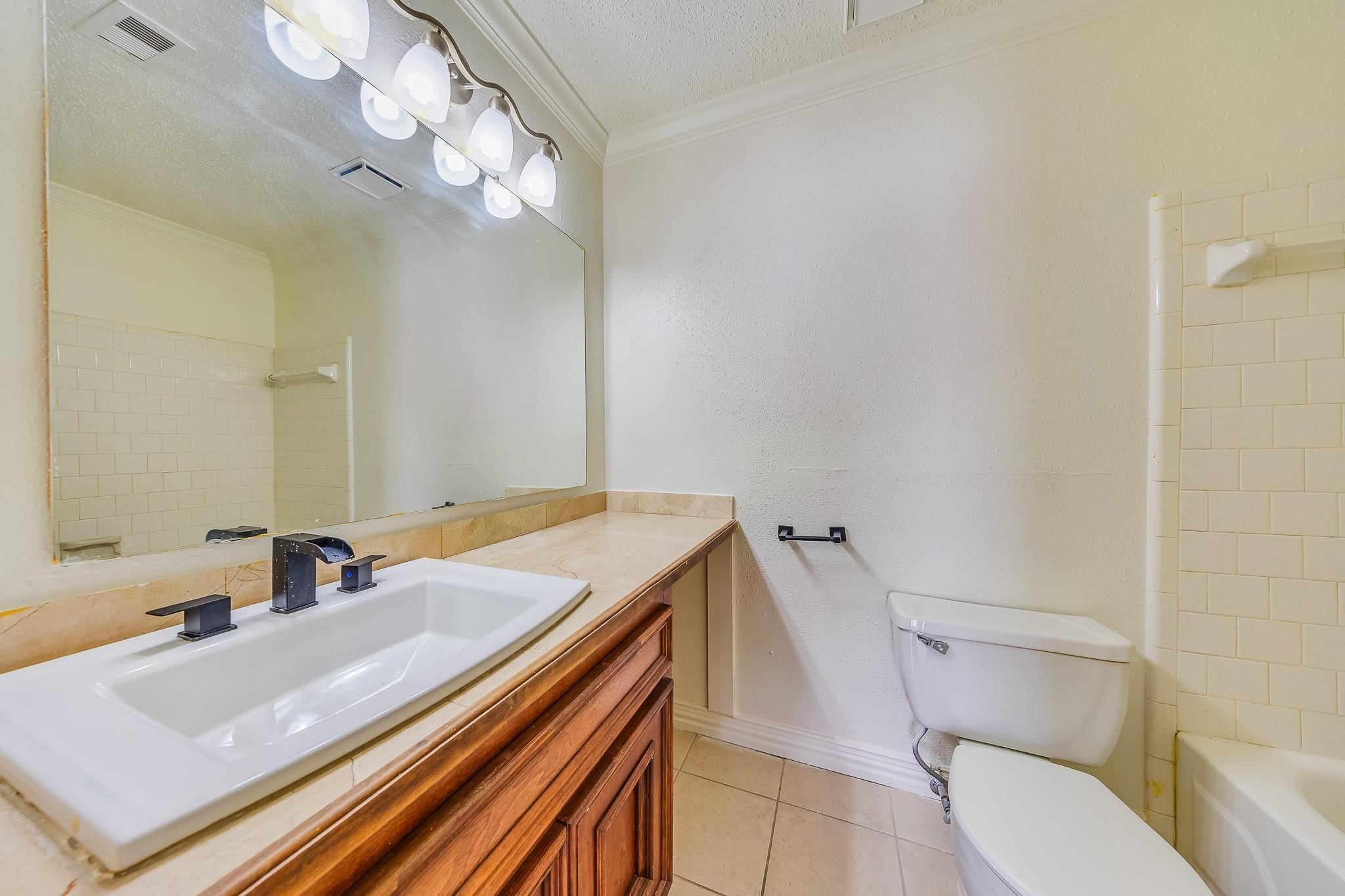 13303 Bridgepath Court Houston, TX 77041 - Photo 12 of 16 a bathroom with a sink toilet vanity and shower