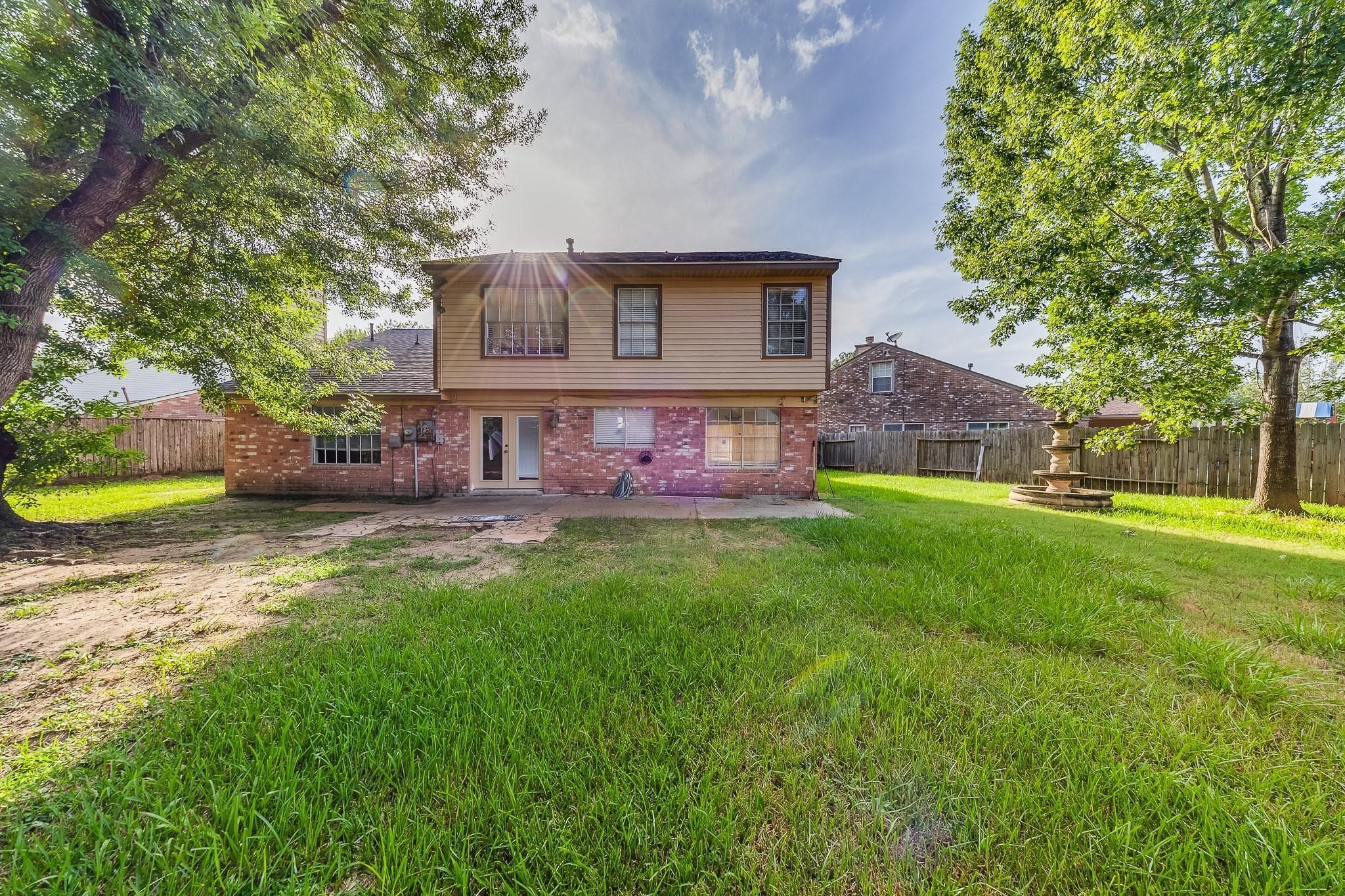 13303 Bridgepath Court Houston, TX 77041 - Photo 14 of 16 a front view of a house with garden