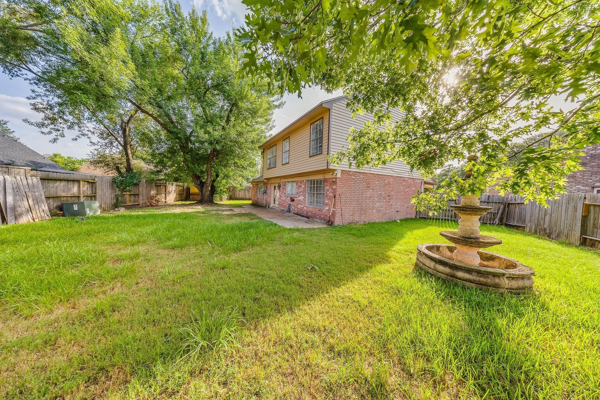 13303 Bridgepath Court Houston, TX 77041 - Photo 16 of 16 a view of a house with a backyard and a patio