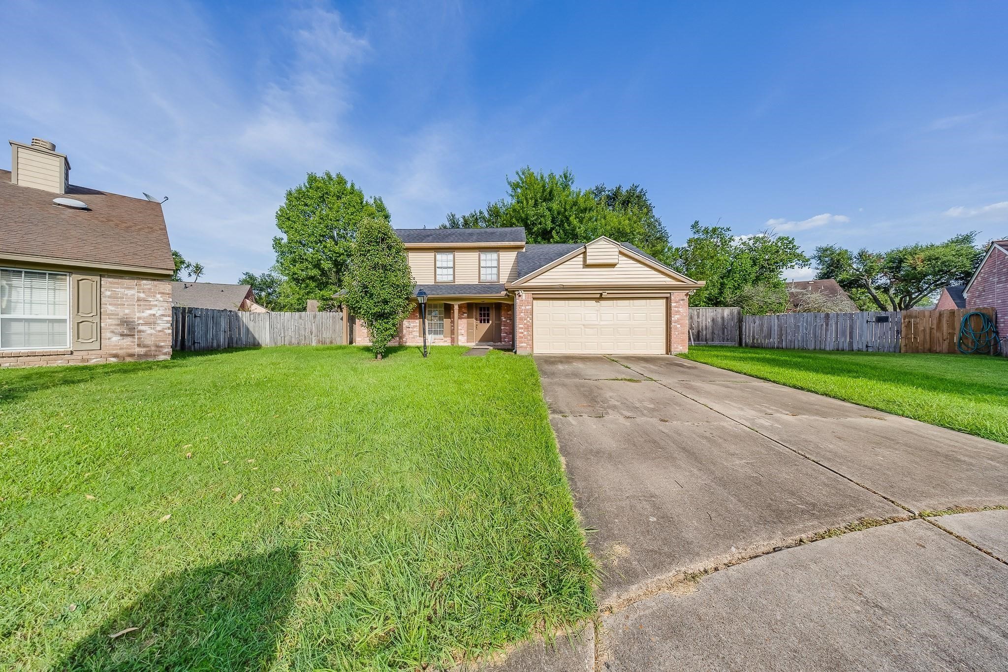 13303 Bridgepath Court Houston, TX 77041 - Photo 2 of 16 a front view of a house with garden