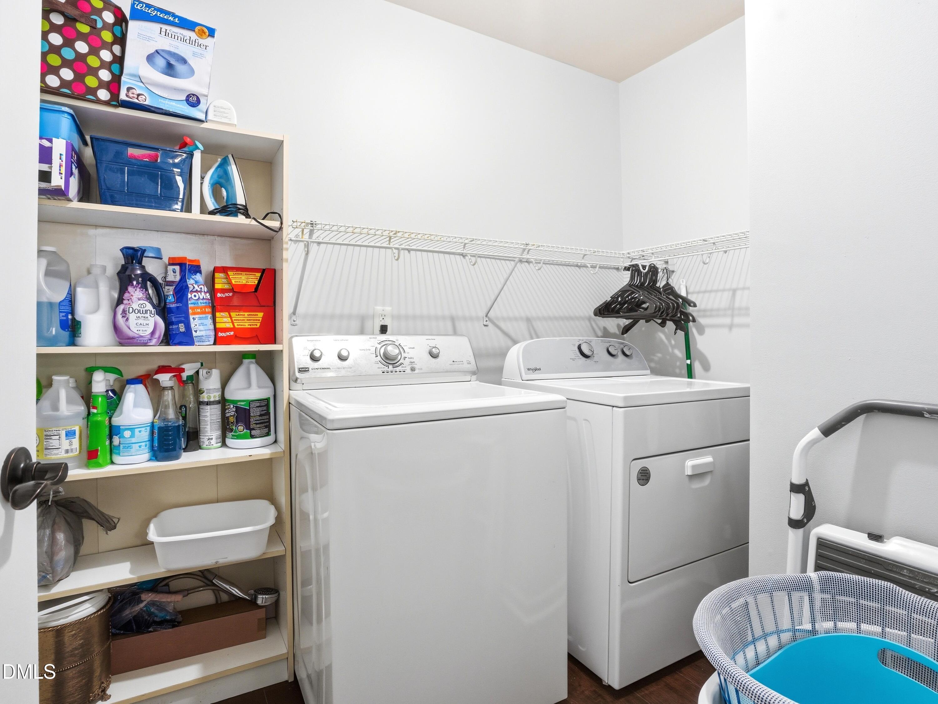 8128 Hovingham Way Raleigh, NC 27616 - Photo 27 of 40 a utility room with dryer washer and a view of living room